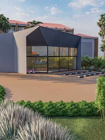 a building with a glass wall and a garden