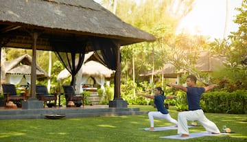 a man and woman doing yoga outside