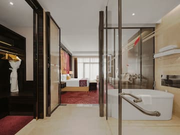 a bathroom with a tub and a bed
