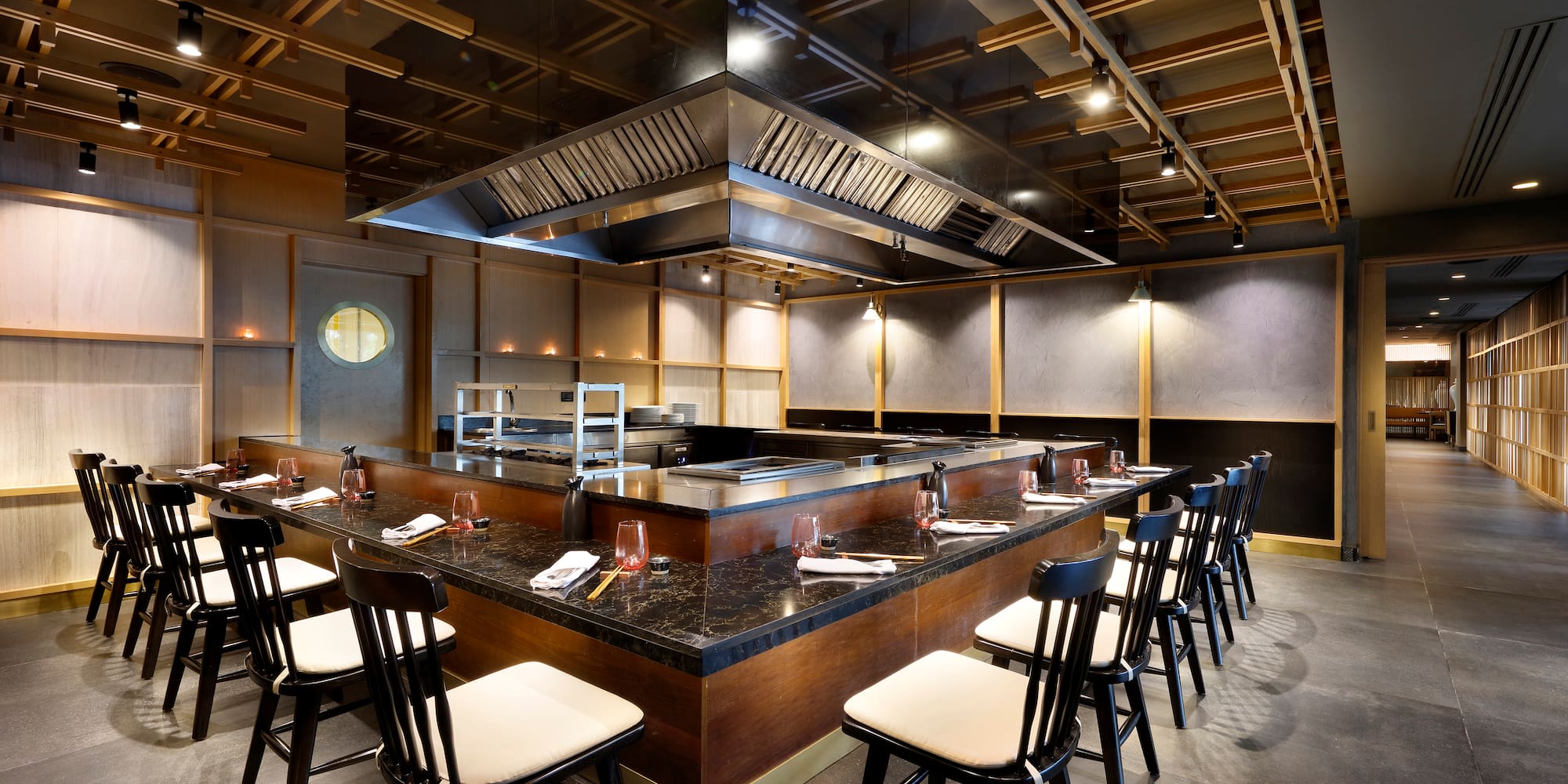 a restaurant with a large counter and chairs