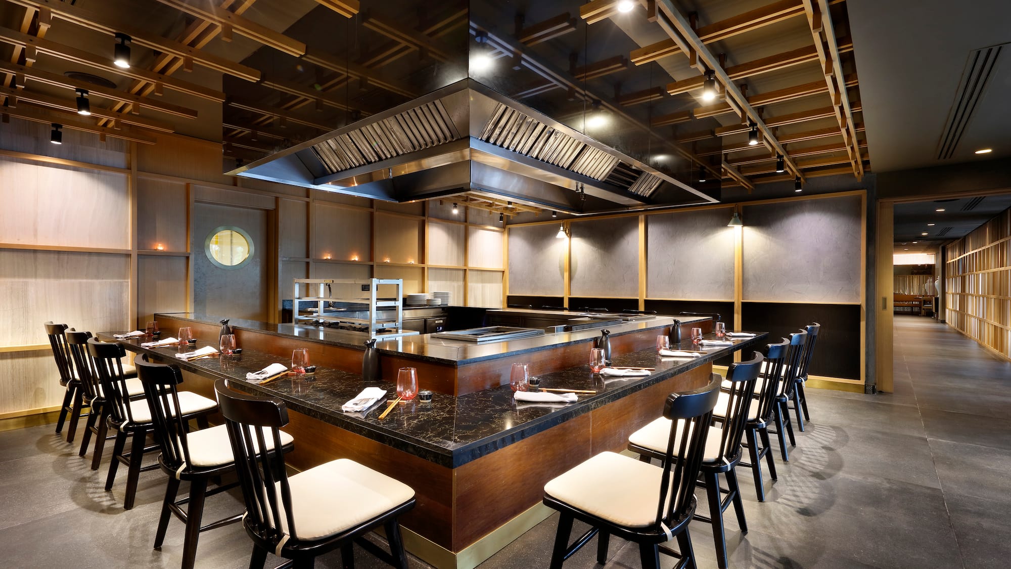 a restaurant with a large counter and chairs