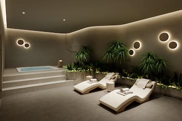 a pool with lounge chairs and plants