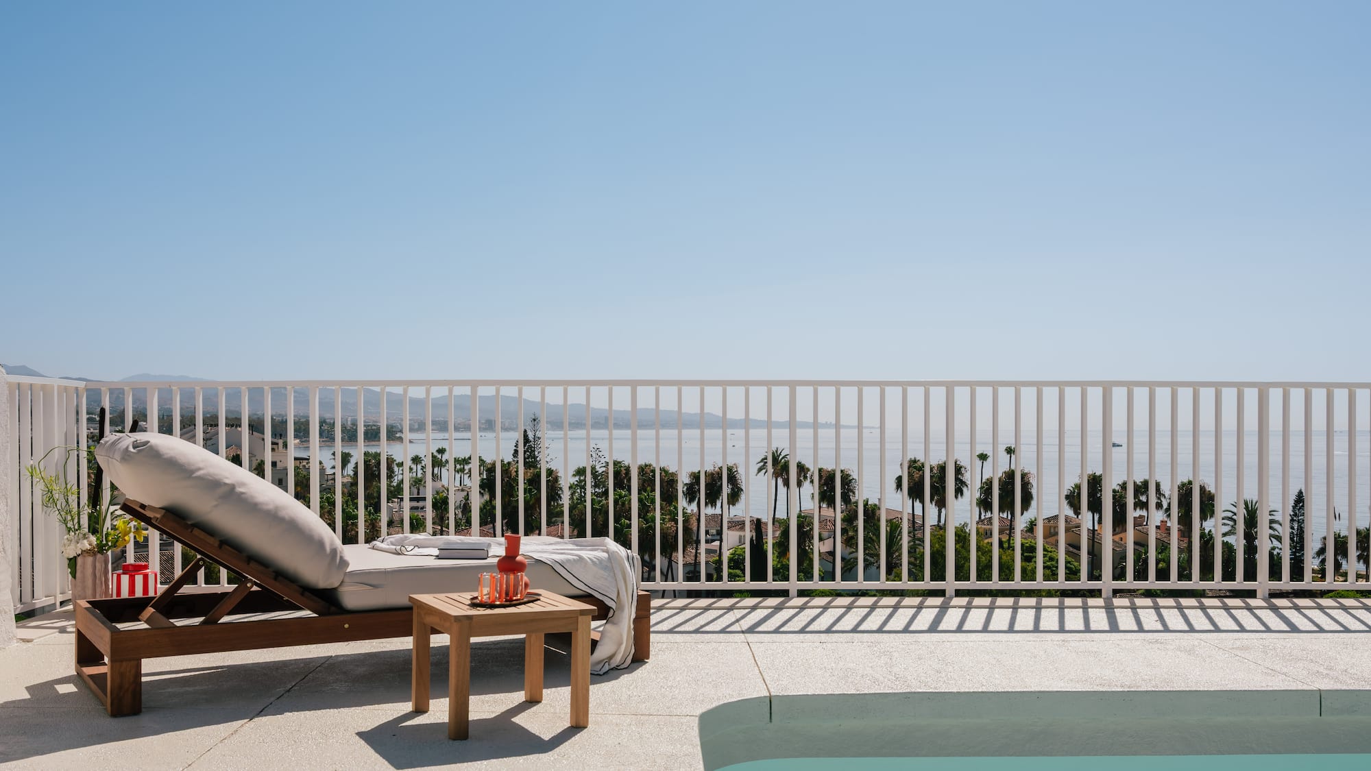 a pool and lounge chair on a deck