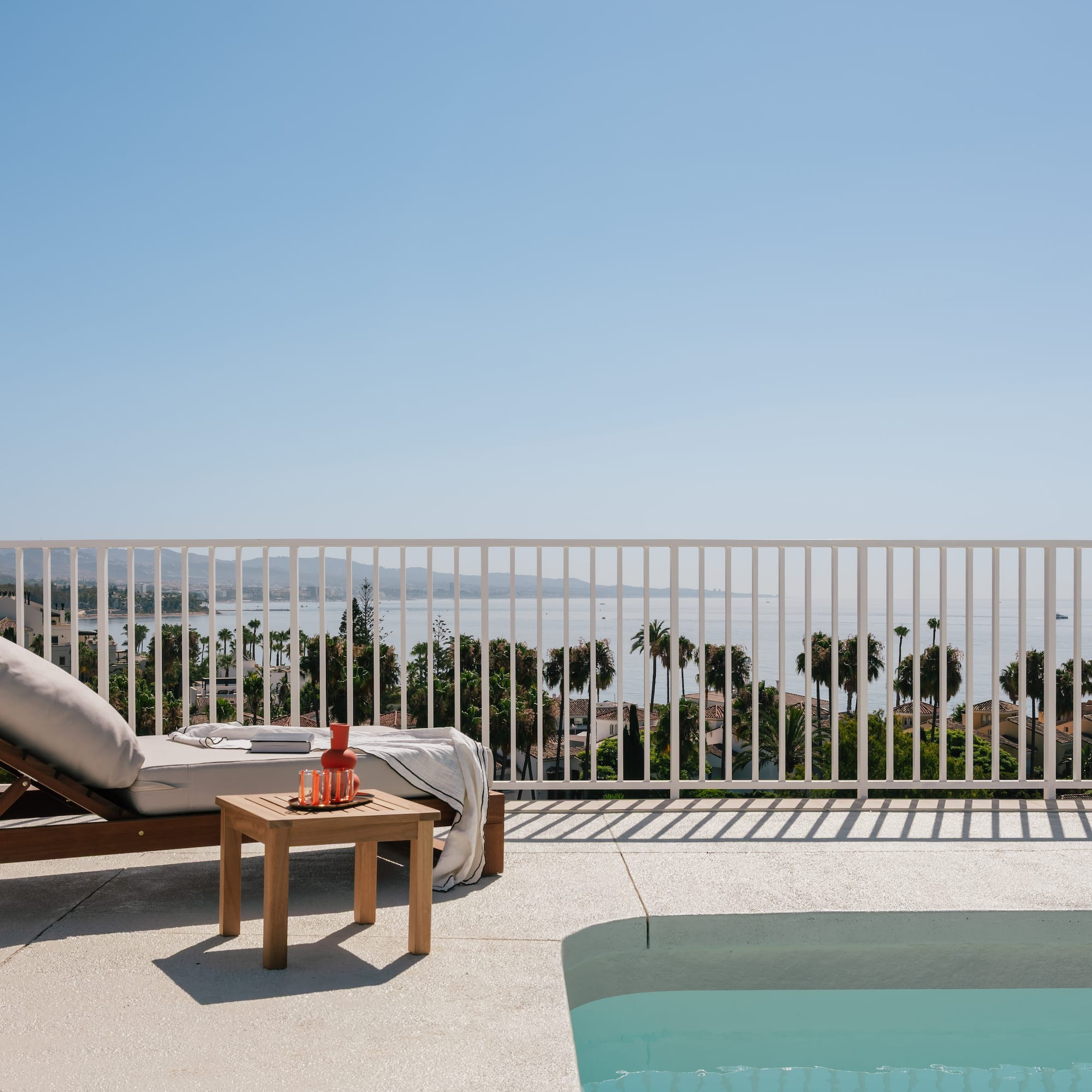 a pool and lounge chair on a deck