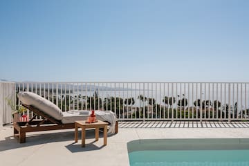 a pool and lounge chair on a deck