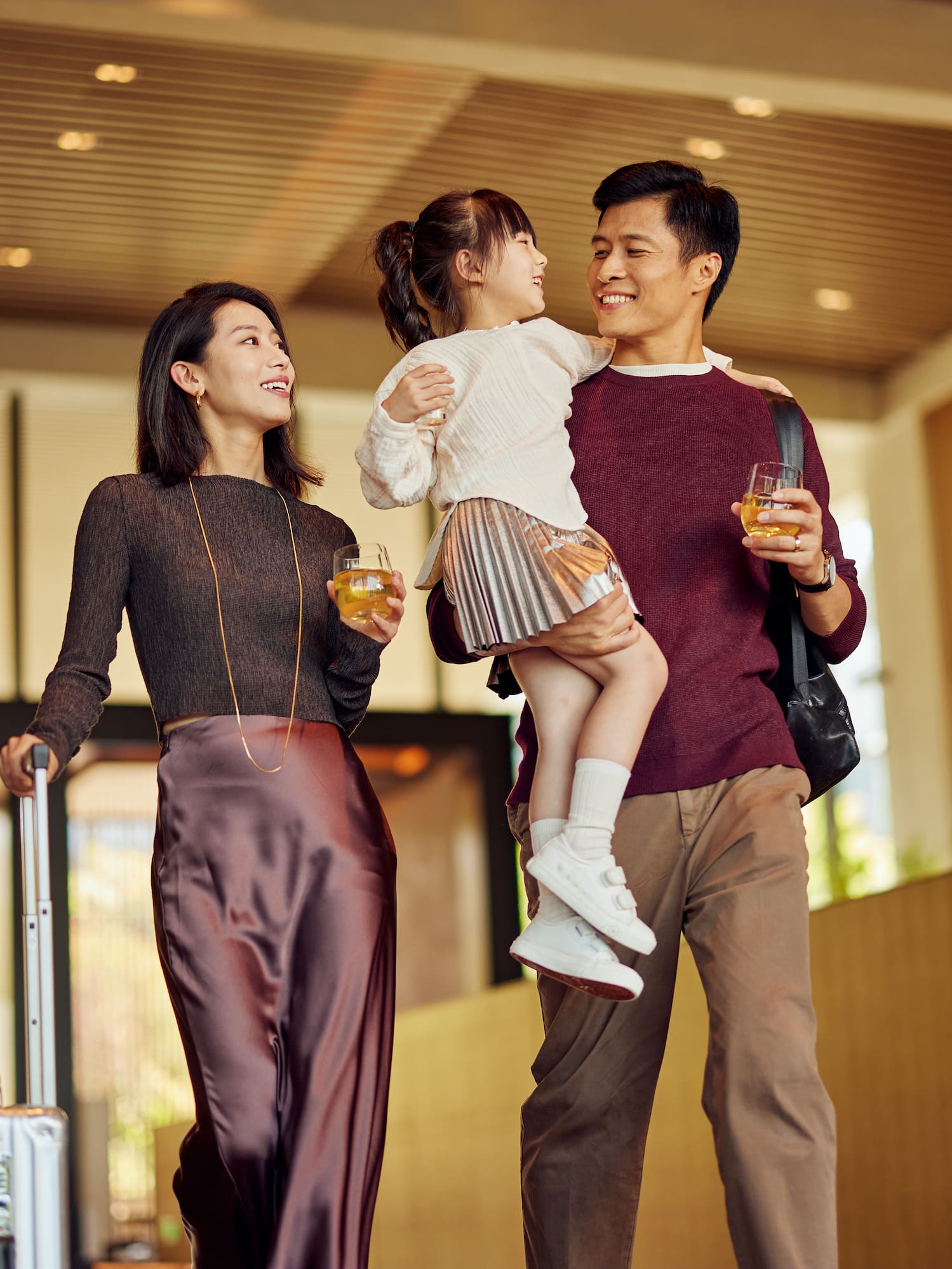 a man and woman holding a child