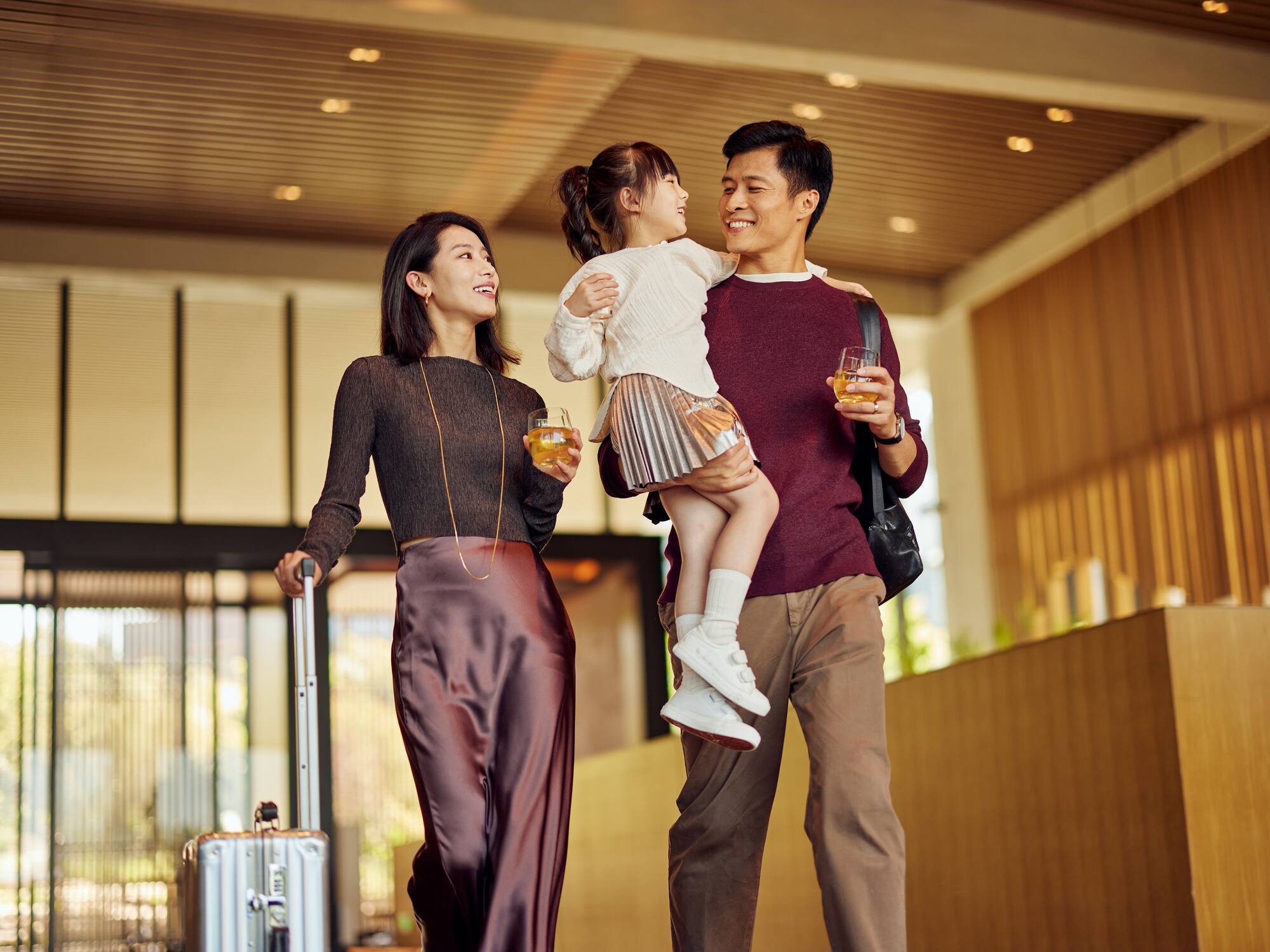 a man and woman holding a child