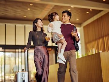 a man and woman holding a child