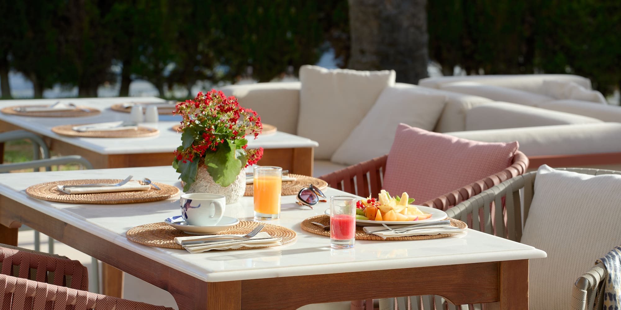 a table with plates of fruit and drinks on it