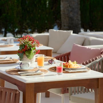 a table with plates of fruit and drinks on it