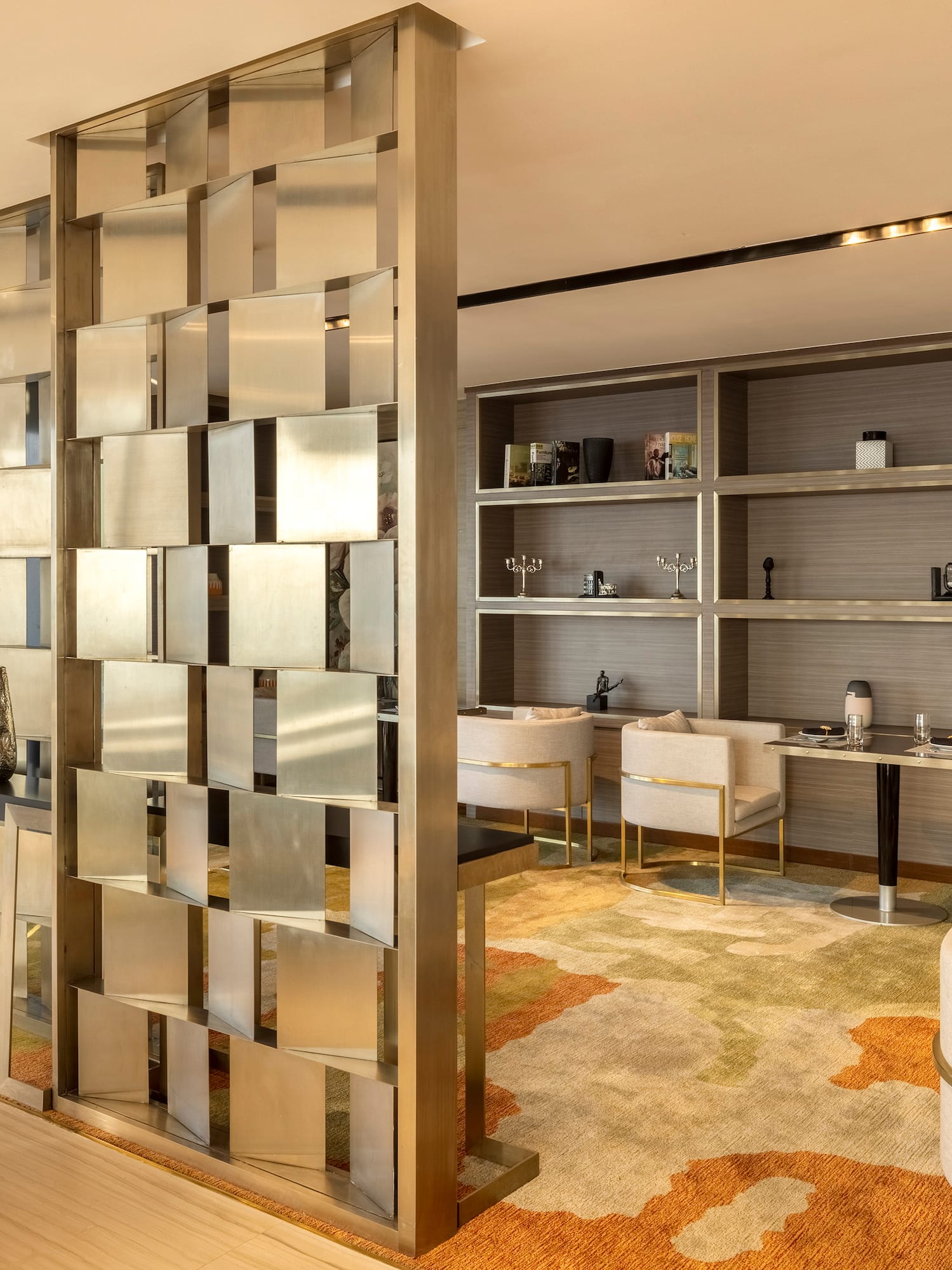 a room with a large screen and shelves