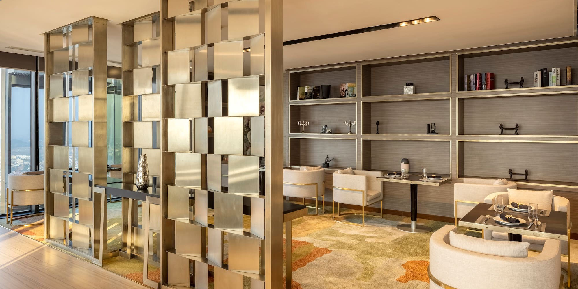 a room with a large screen and shelves