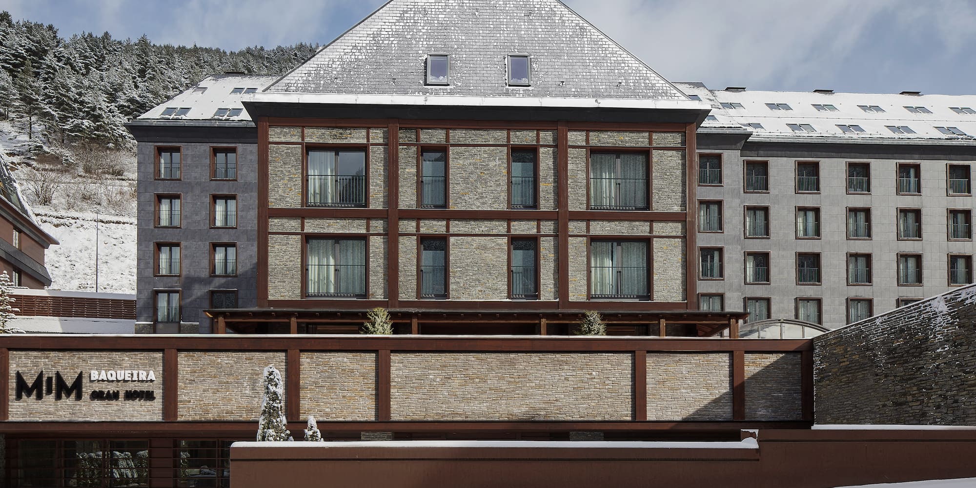 a building with a fence and snow