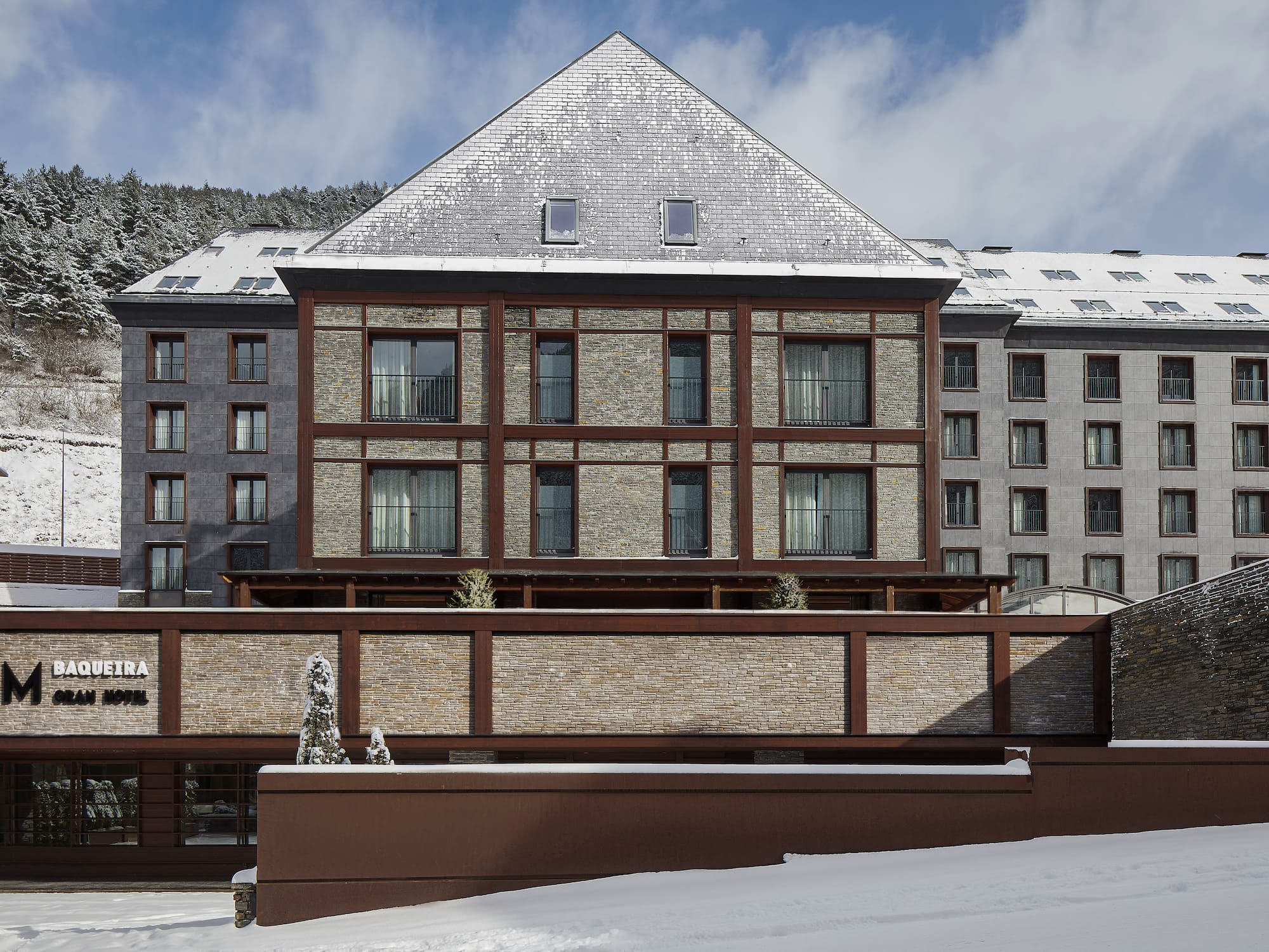 a building with a fence and snow