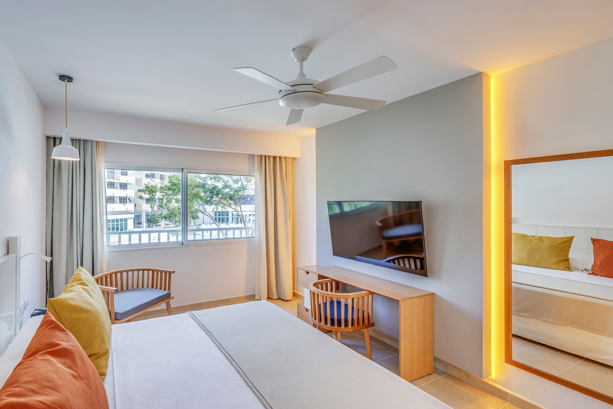 a room with a bed and a desk and chair