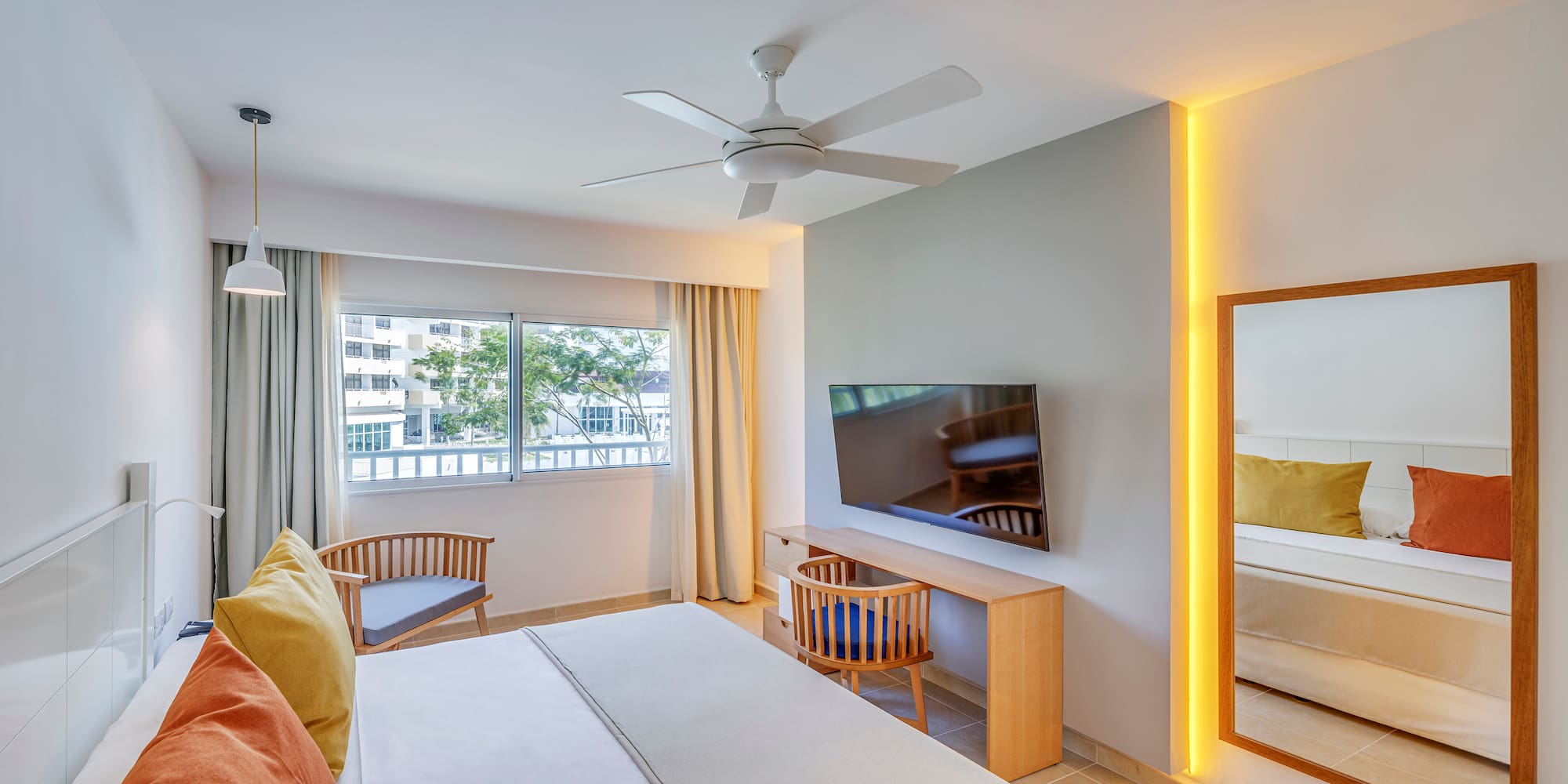 a room with a bed and a desk and chair