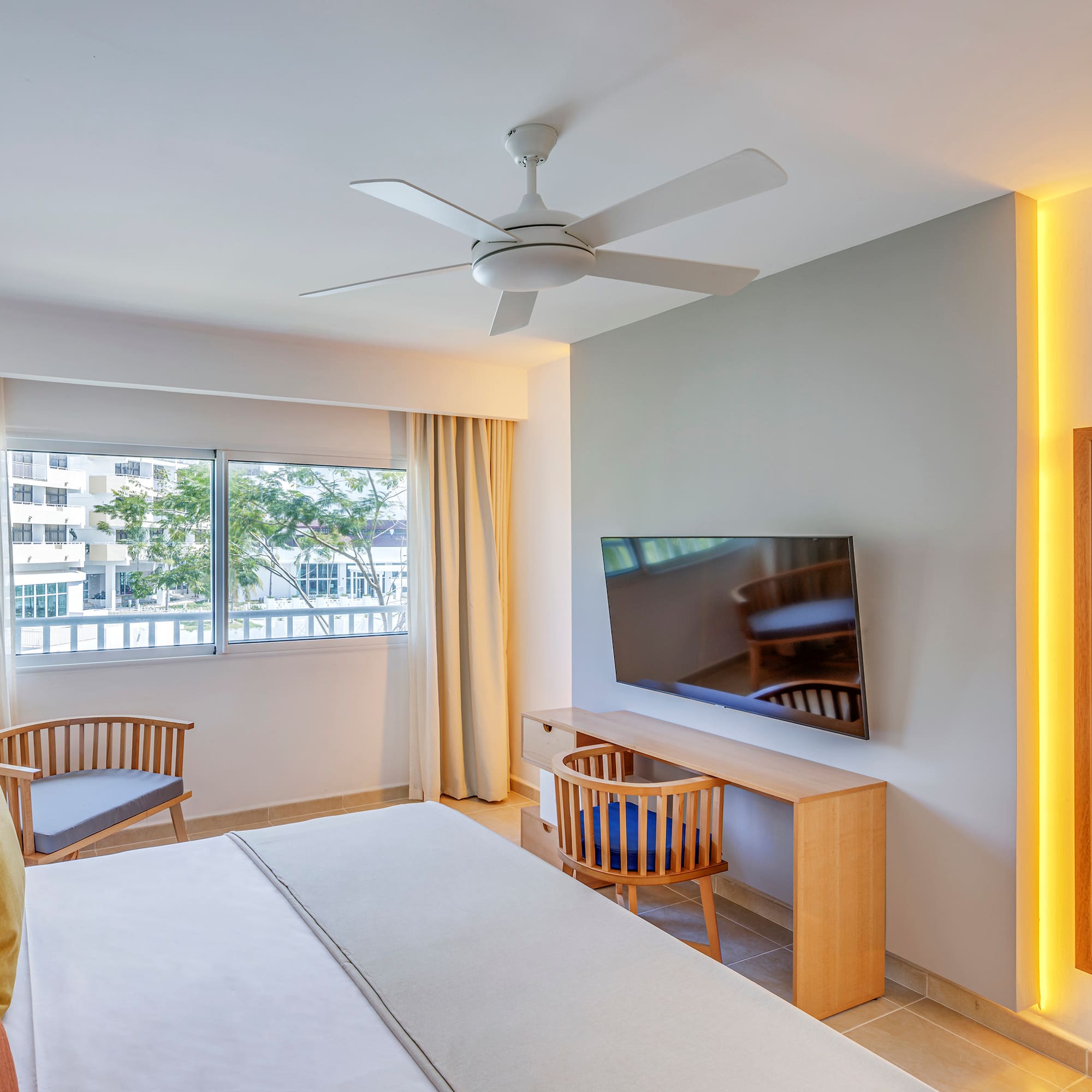 a room with a bed and a desk and chair