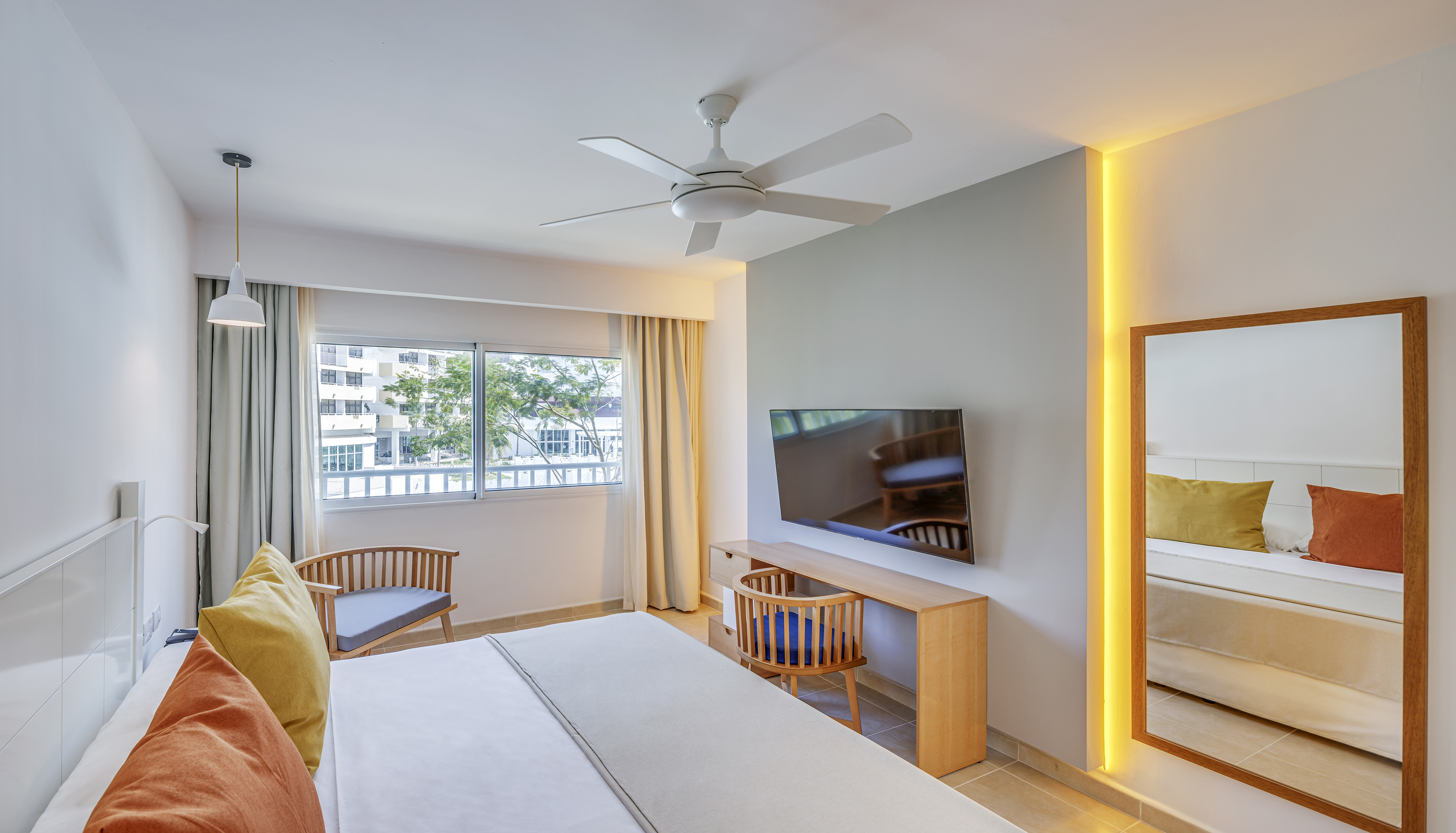 a room with a bed and a desk and chair