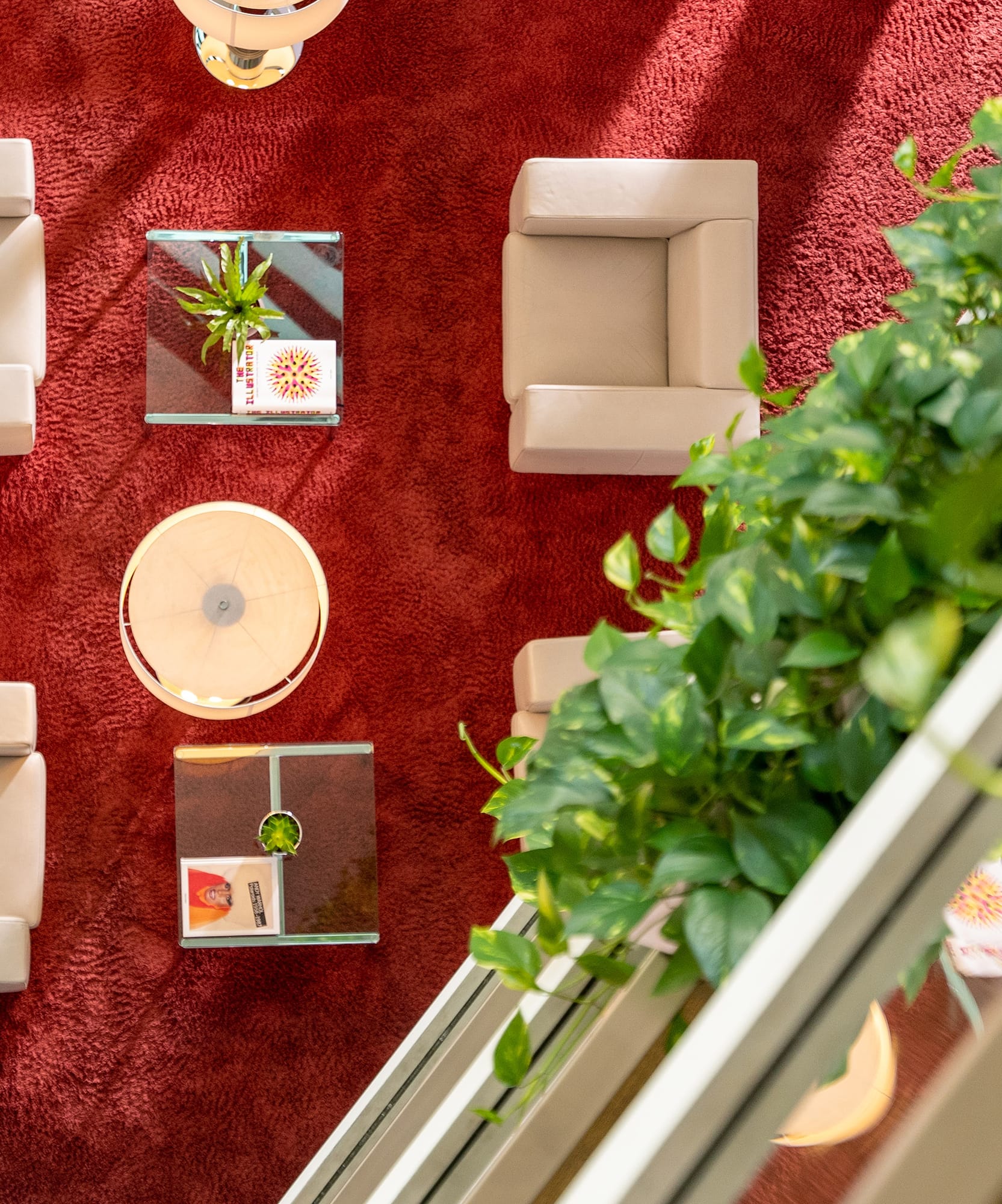 a room with a red carpet and white chairs