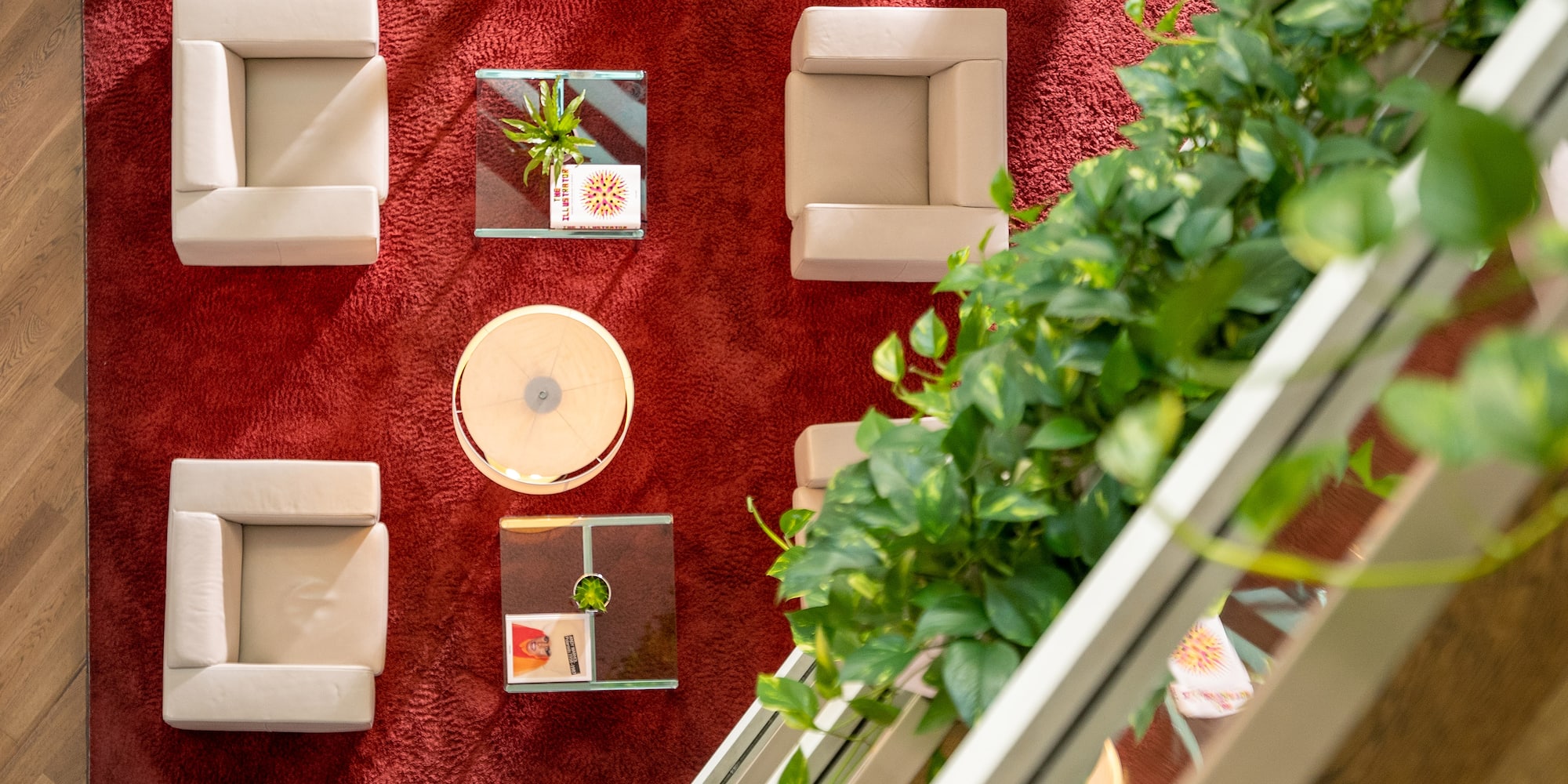 a room with a red carpet and white chairs