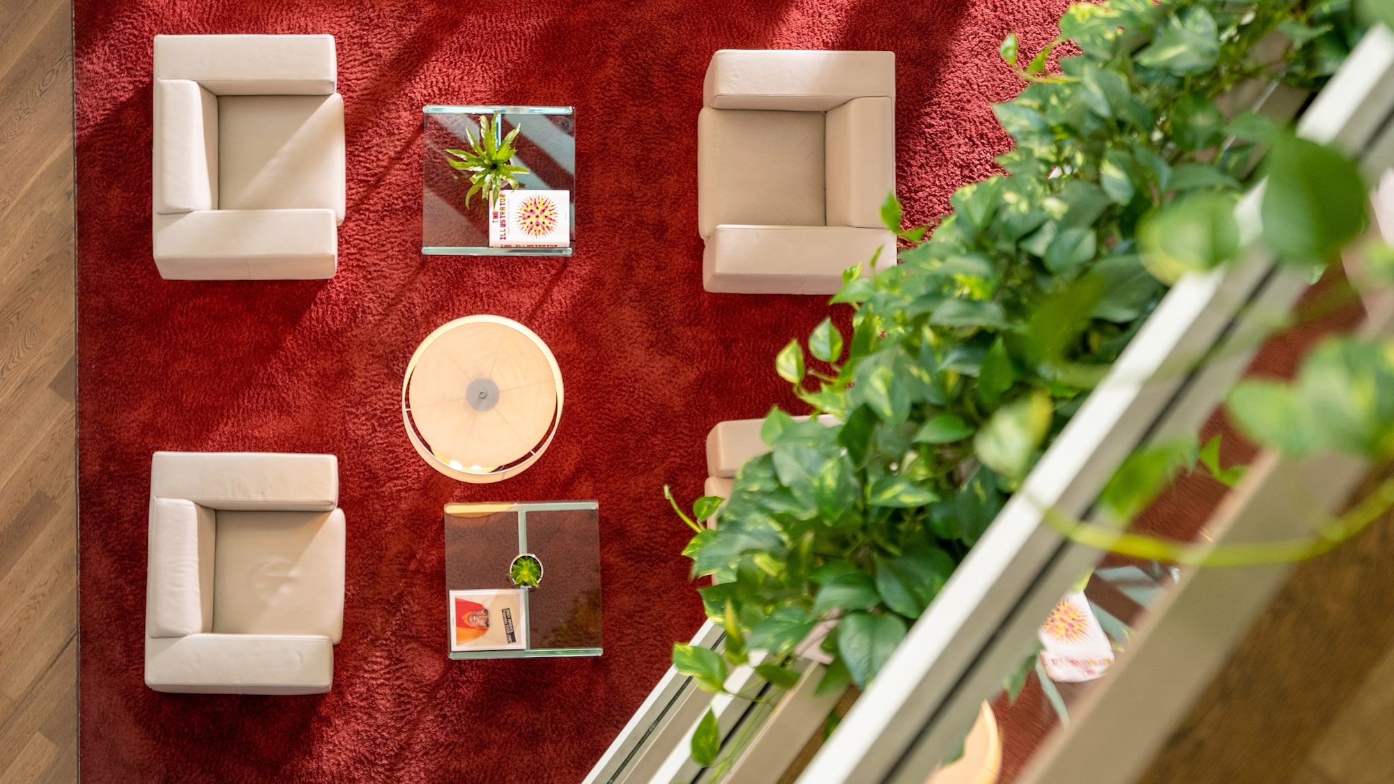 a room with a red carpet and white chairs