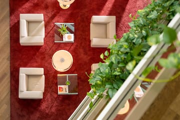 a room with a red carpet and white chairs