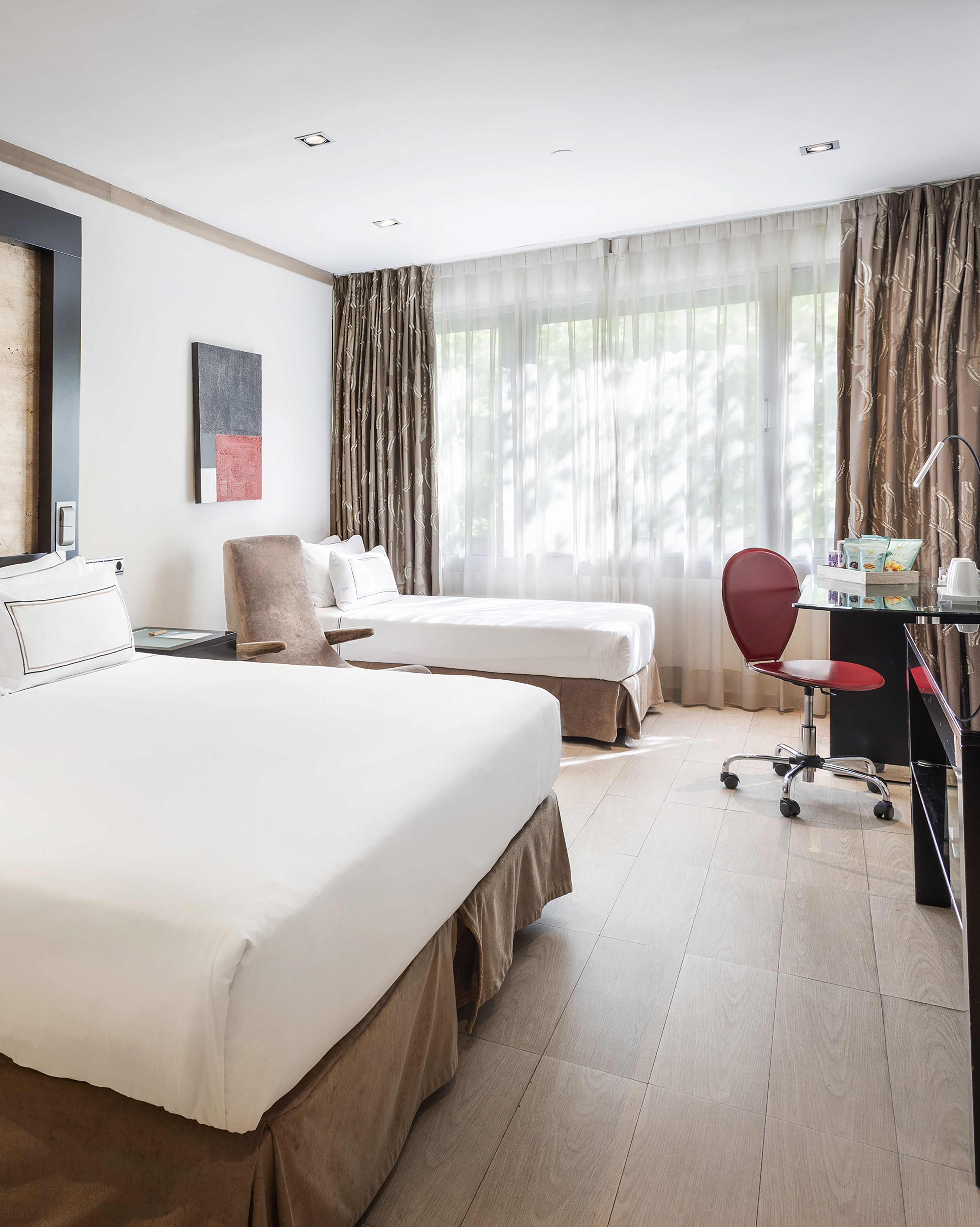 a room with two beds and a desk