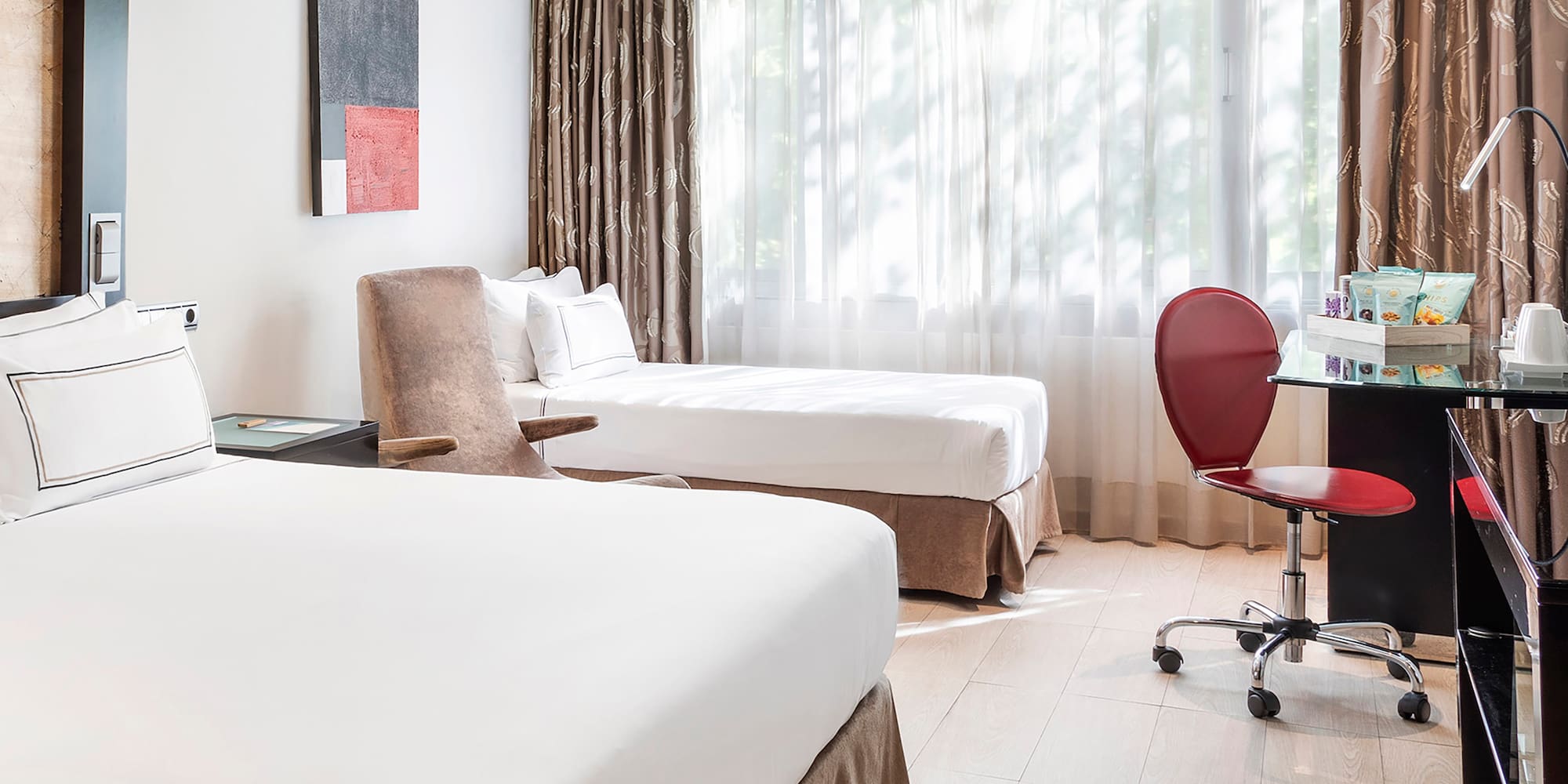 a room with two beds and a desk