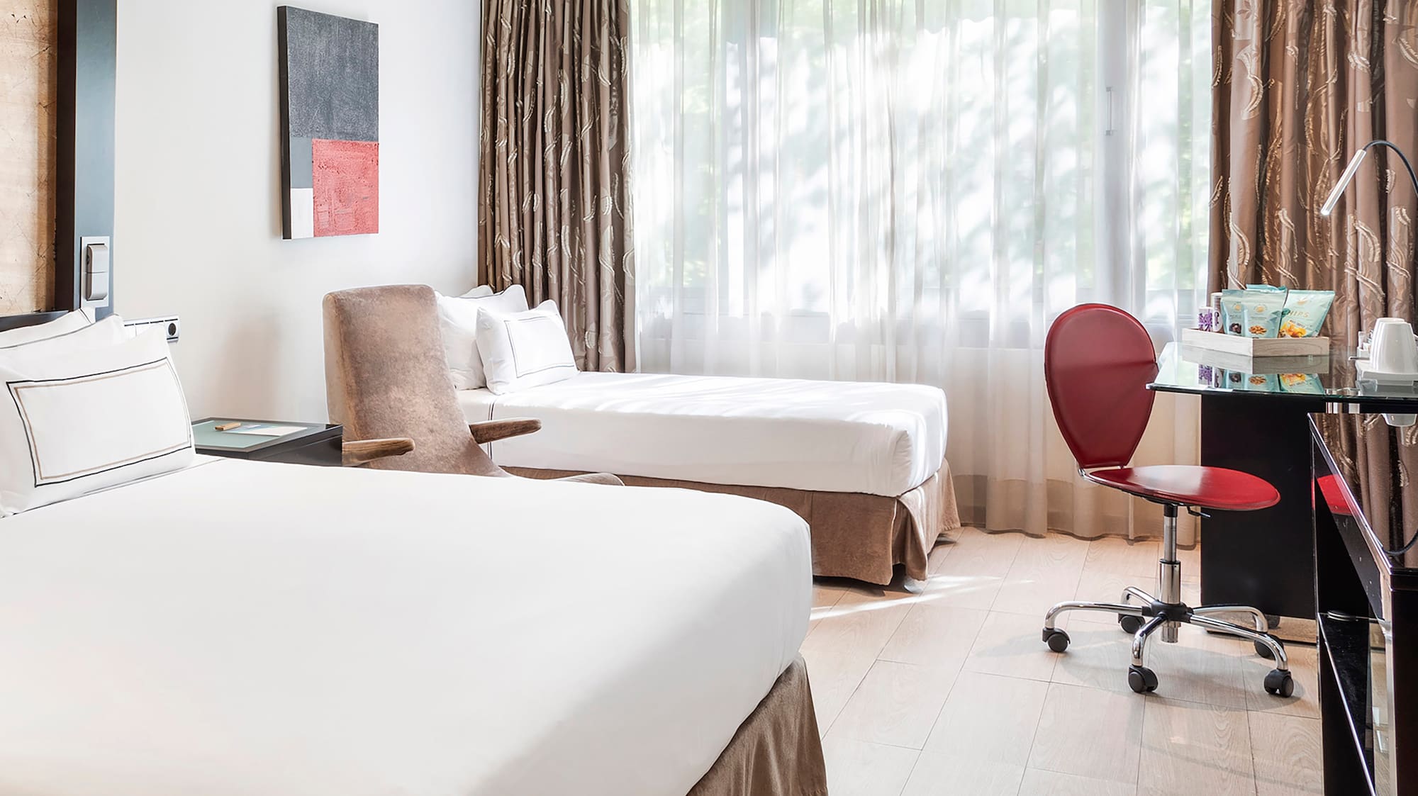 a room with two beds and a desk