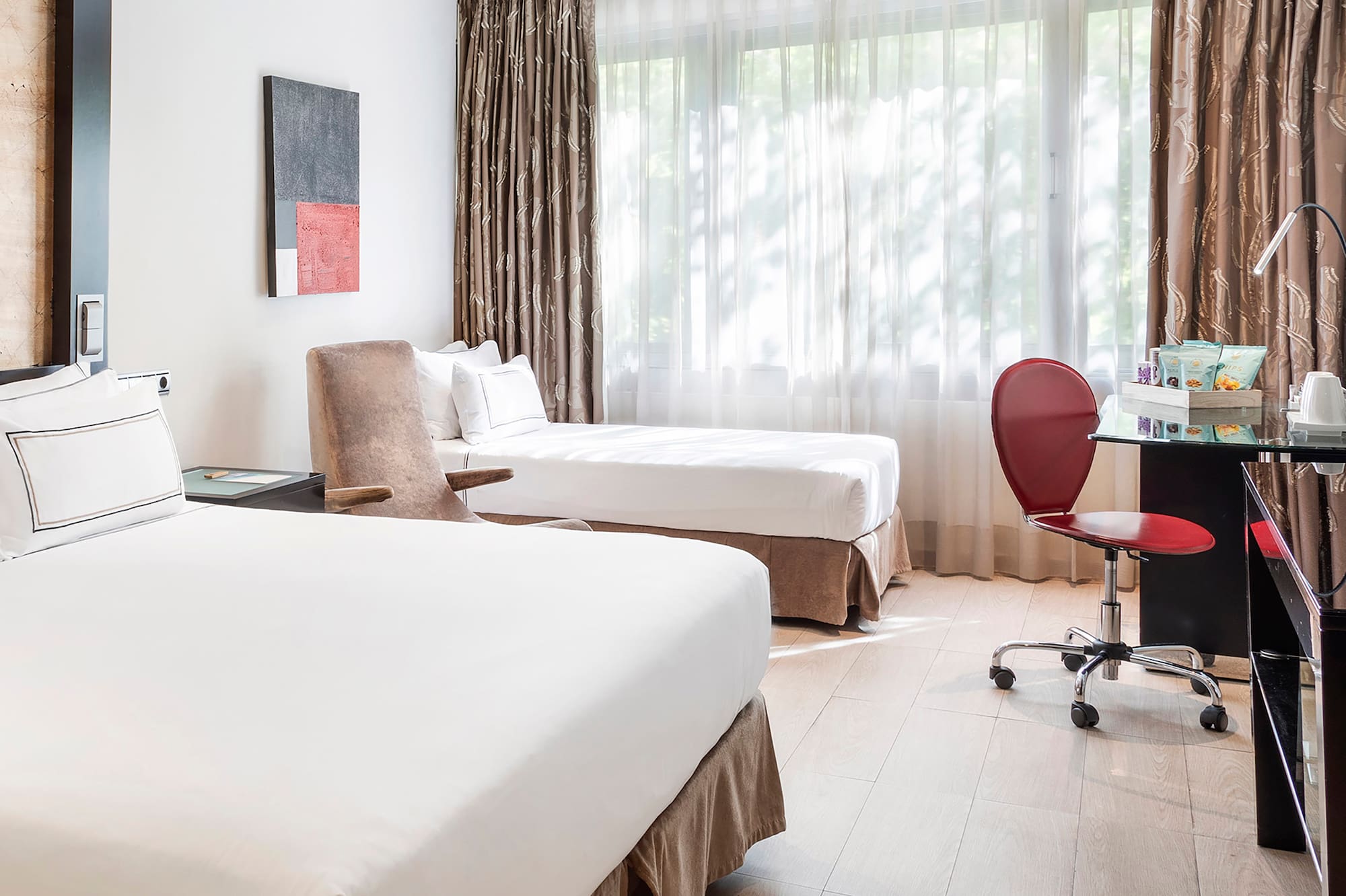 a room with two beds and a desk