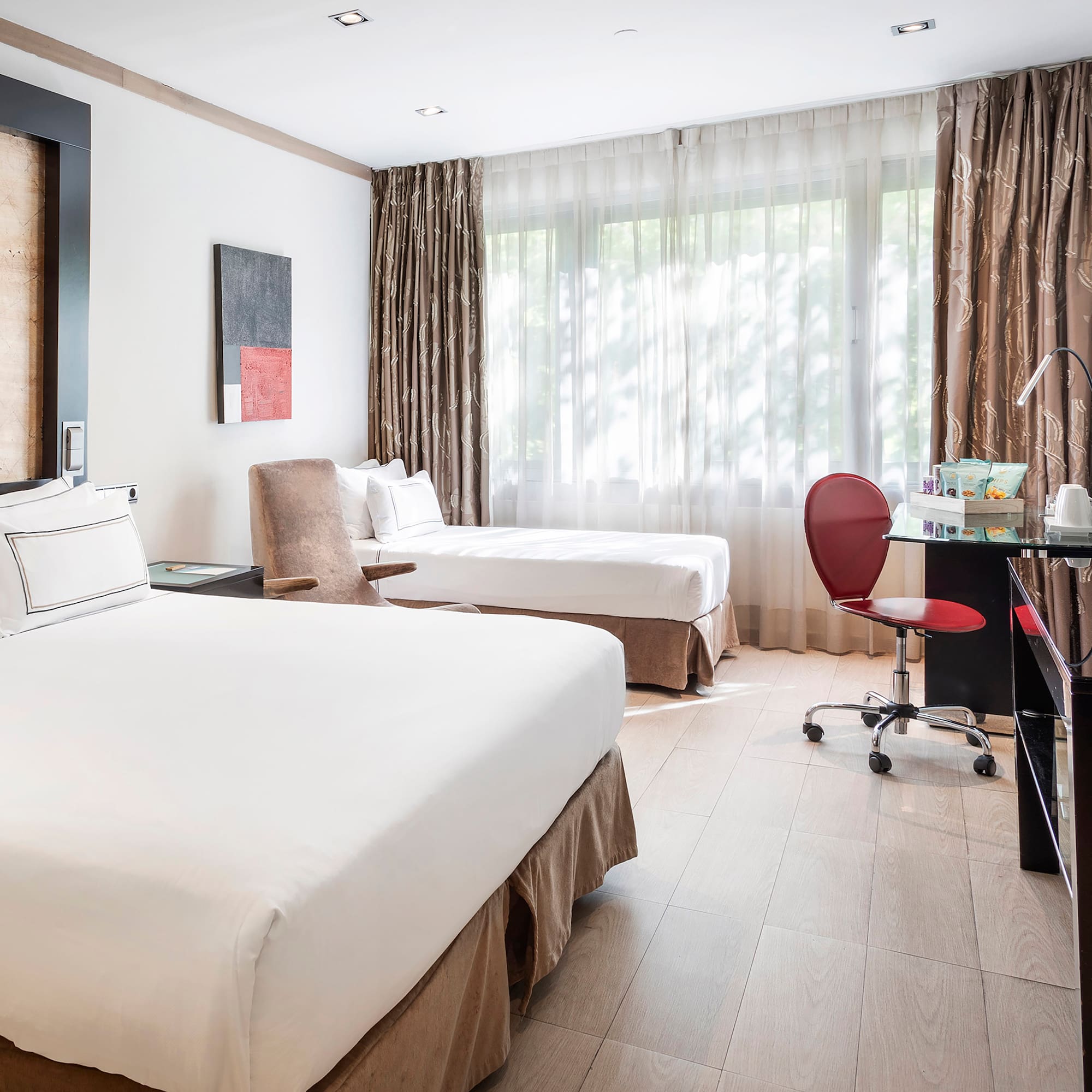 a room with two beds and a desk