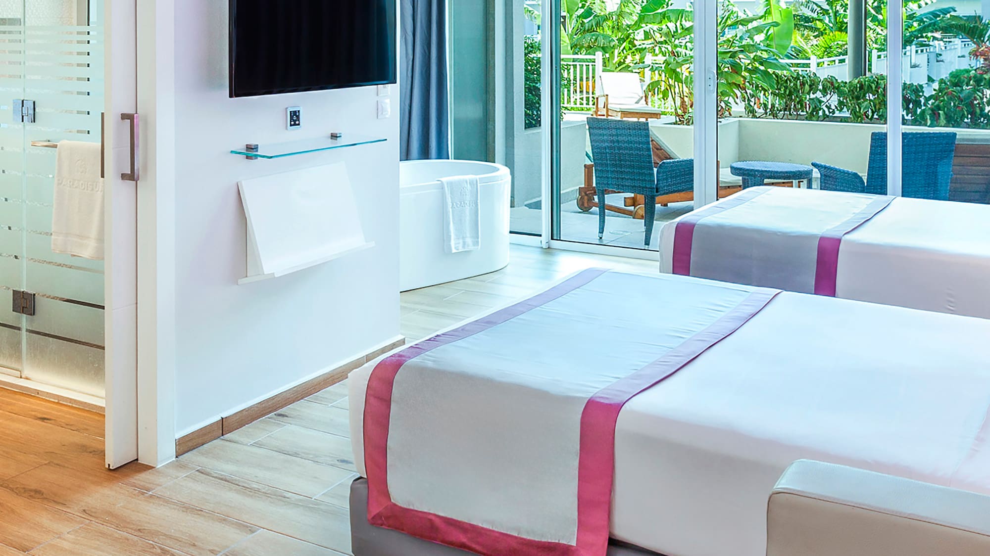 a room with two beds and a television