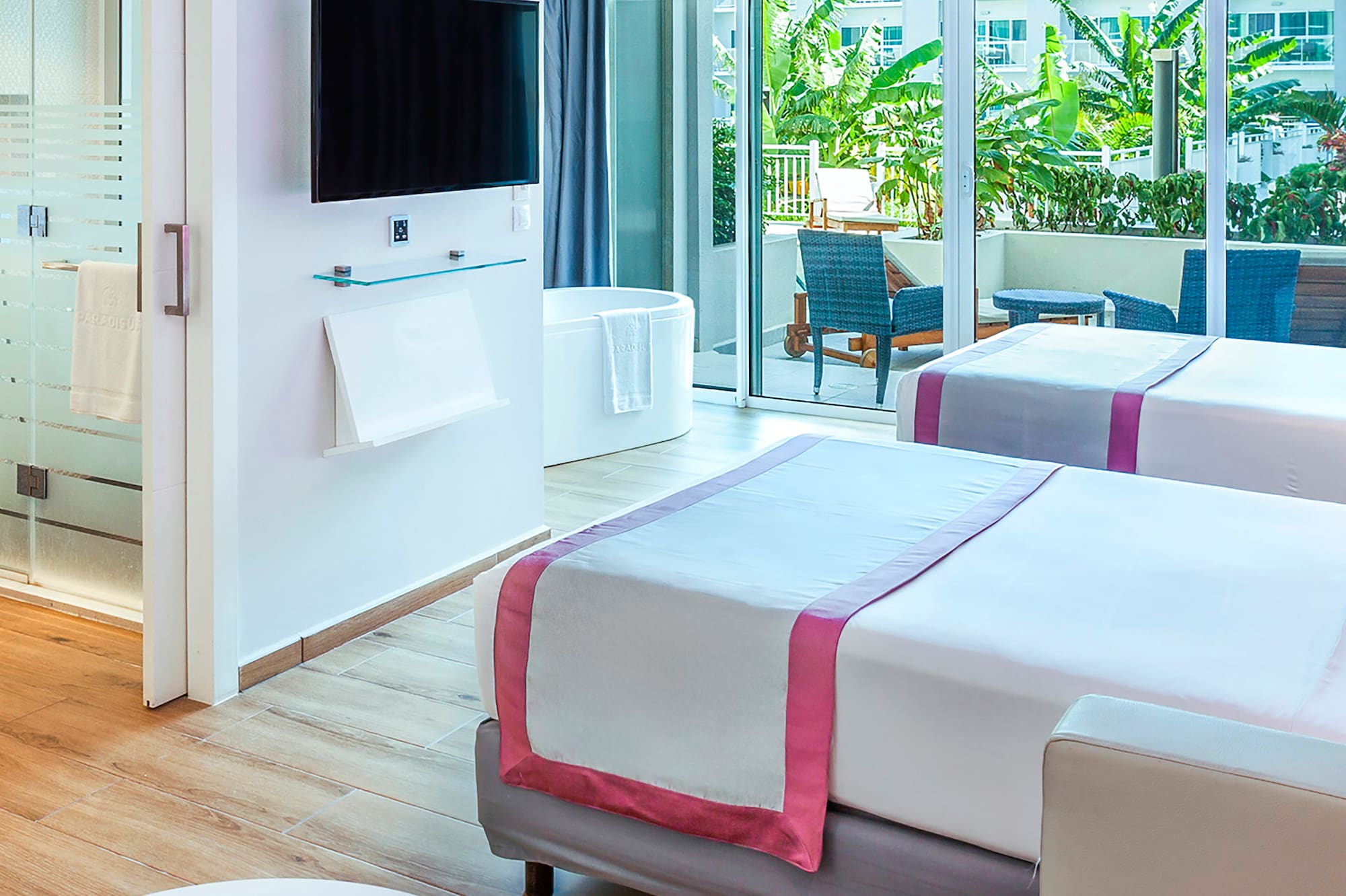 a room with two beds and a television