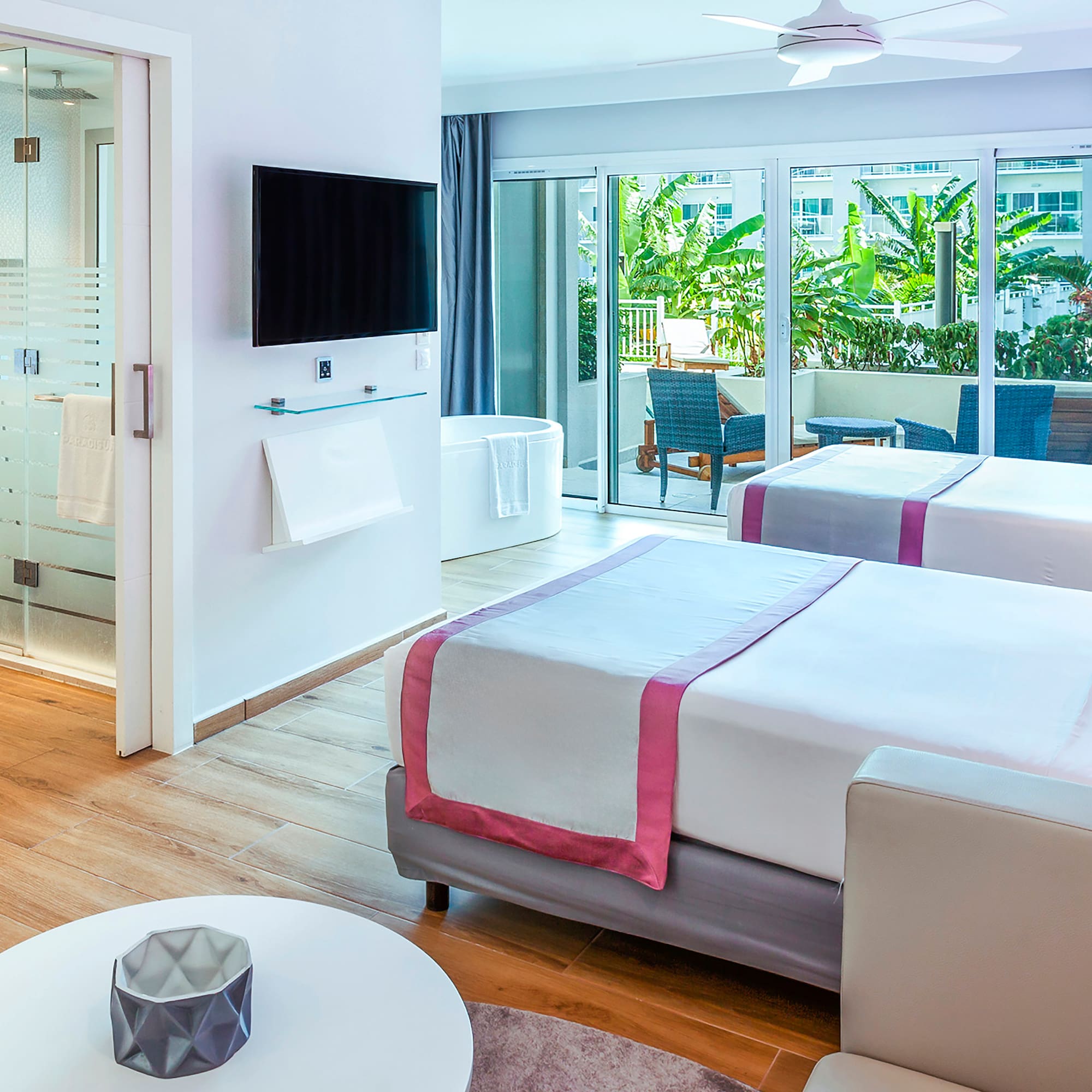 a room with two beds and a television