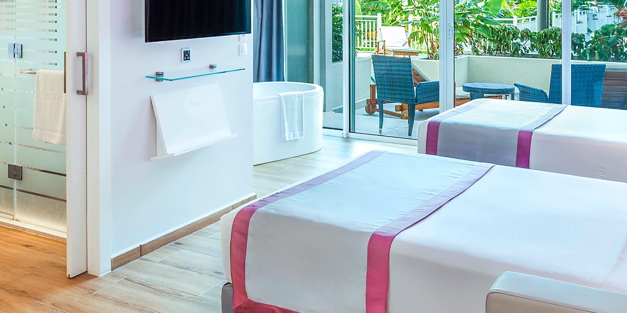 a room with two beds and a television