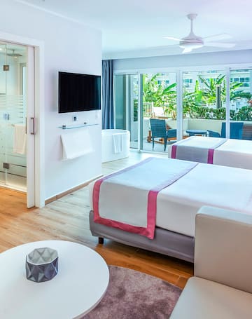 a room with two beds and a television