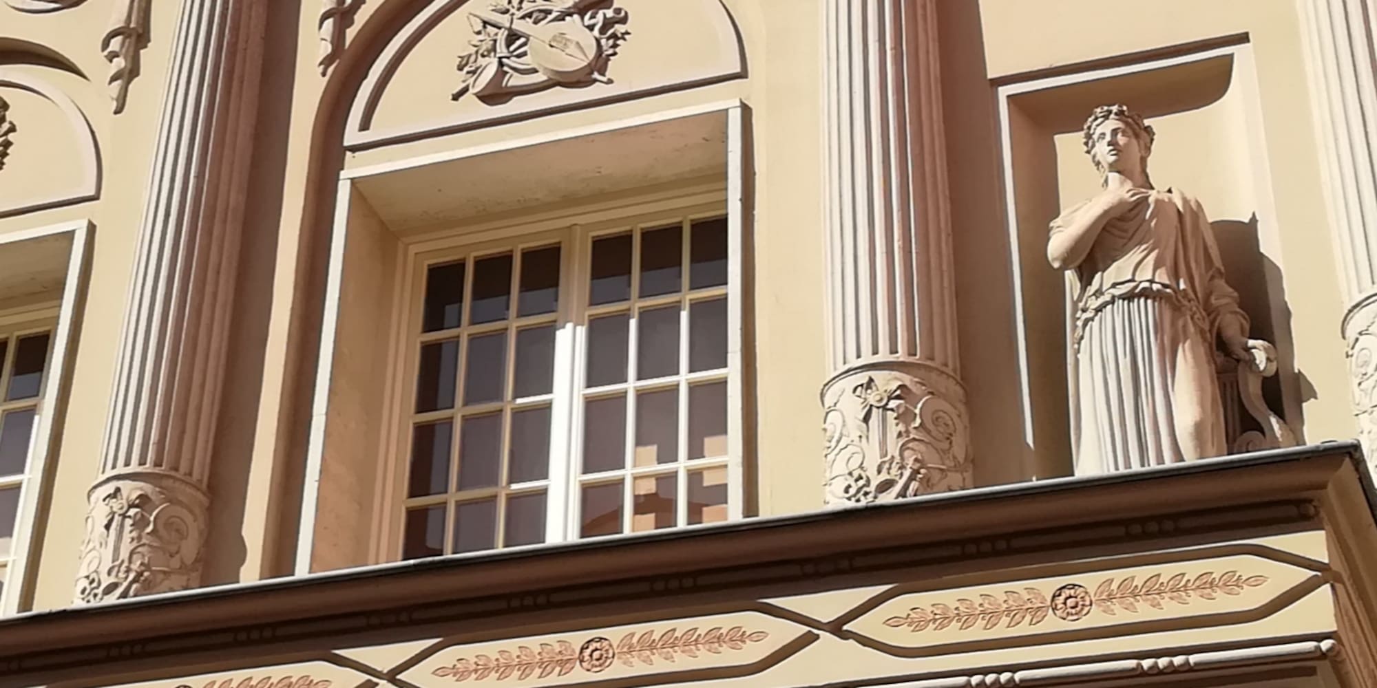 a building with statues on the balcony