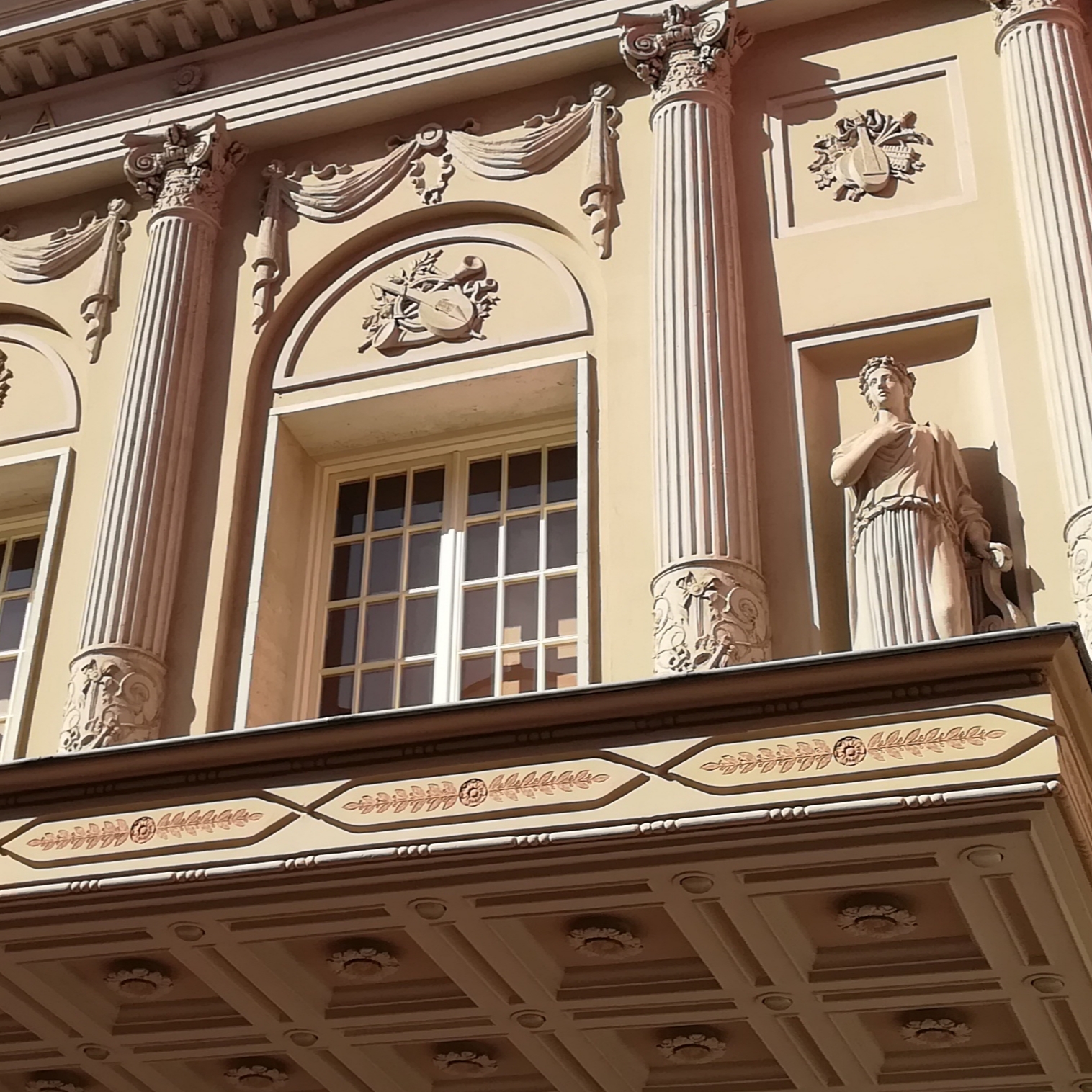 a building with statues on the balcony
