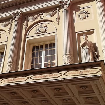 a building with statues on the balcony