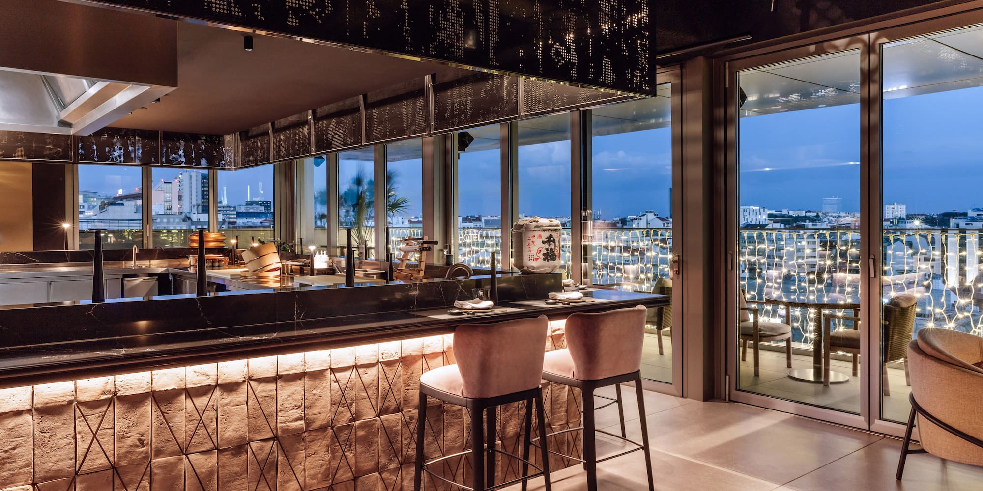 a bar with chairs and a view of a city