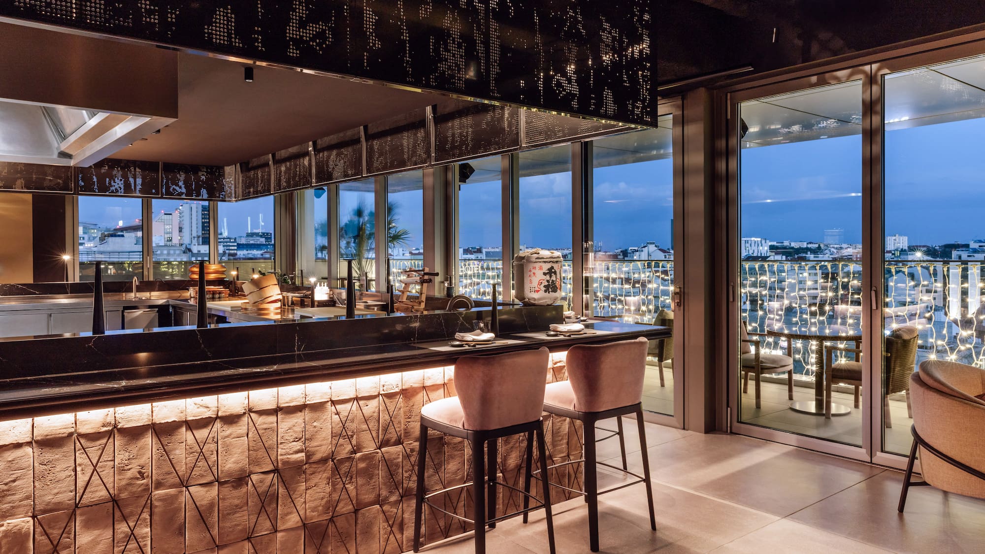 a bar with chairs and a view of the city from the window