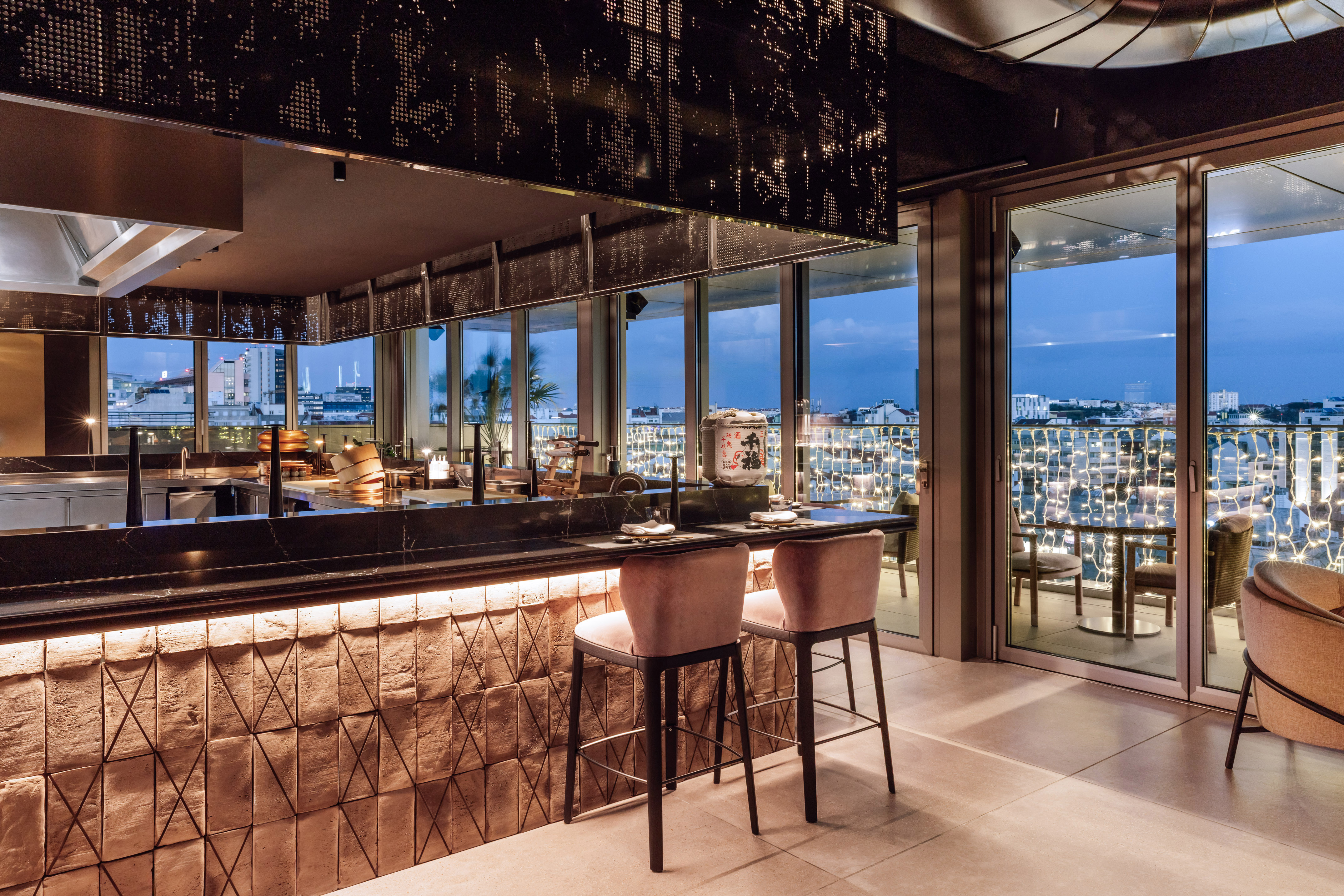 Rooftop restaurant bar with city view at twilight, modern interior design.