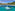 Catamarán de lujo en aguas turquesas del Caribe, con playa y montañas tropicales.