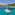 MIM OCEAN catamaran anchored in clear turquoise bay with tropical hills.