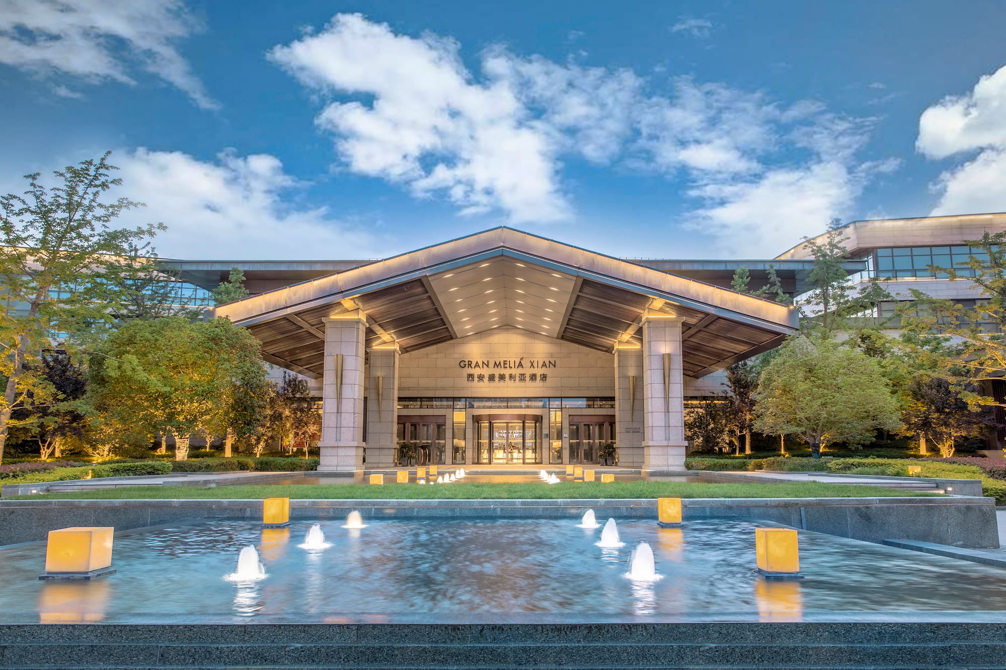 Gran Meliá Xian luxury hotel entrance, lit fountain, modern design.