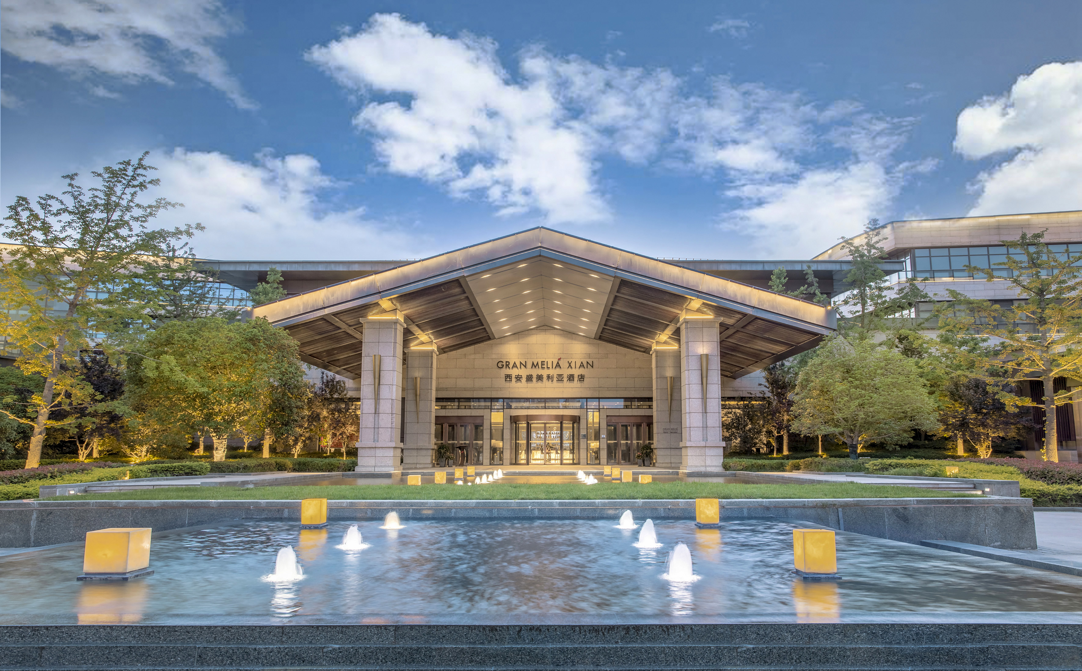 Gran Meliá Xian luxury hotel entrance, lit fountain, modern design.