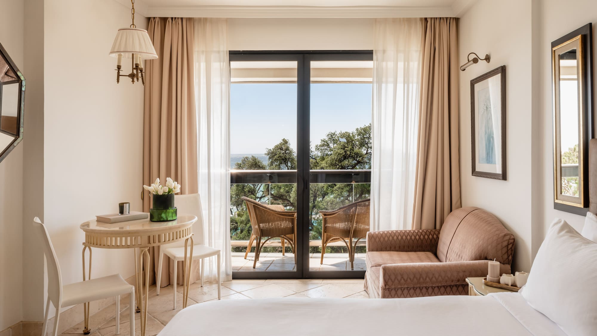 a room with a bed and a table and chairs