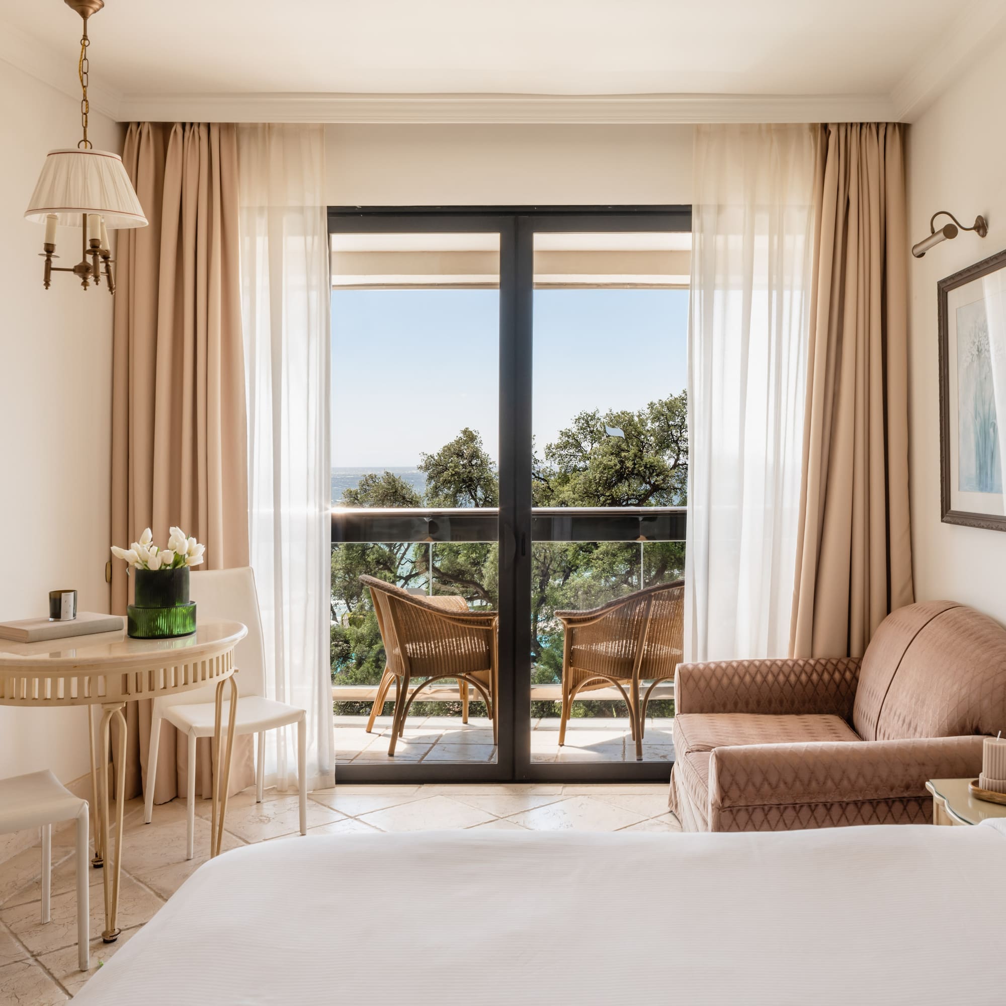 a room with a bed and a table and chairs