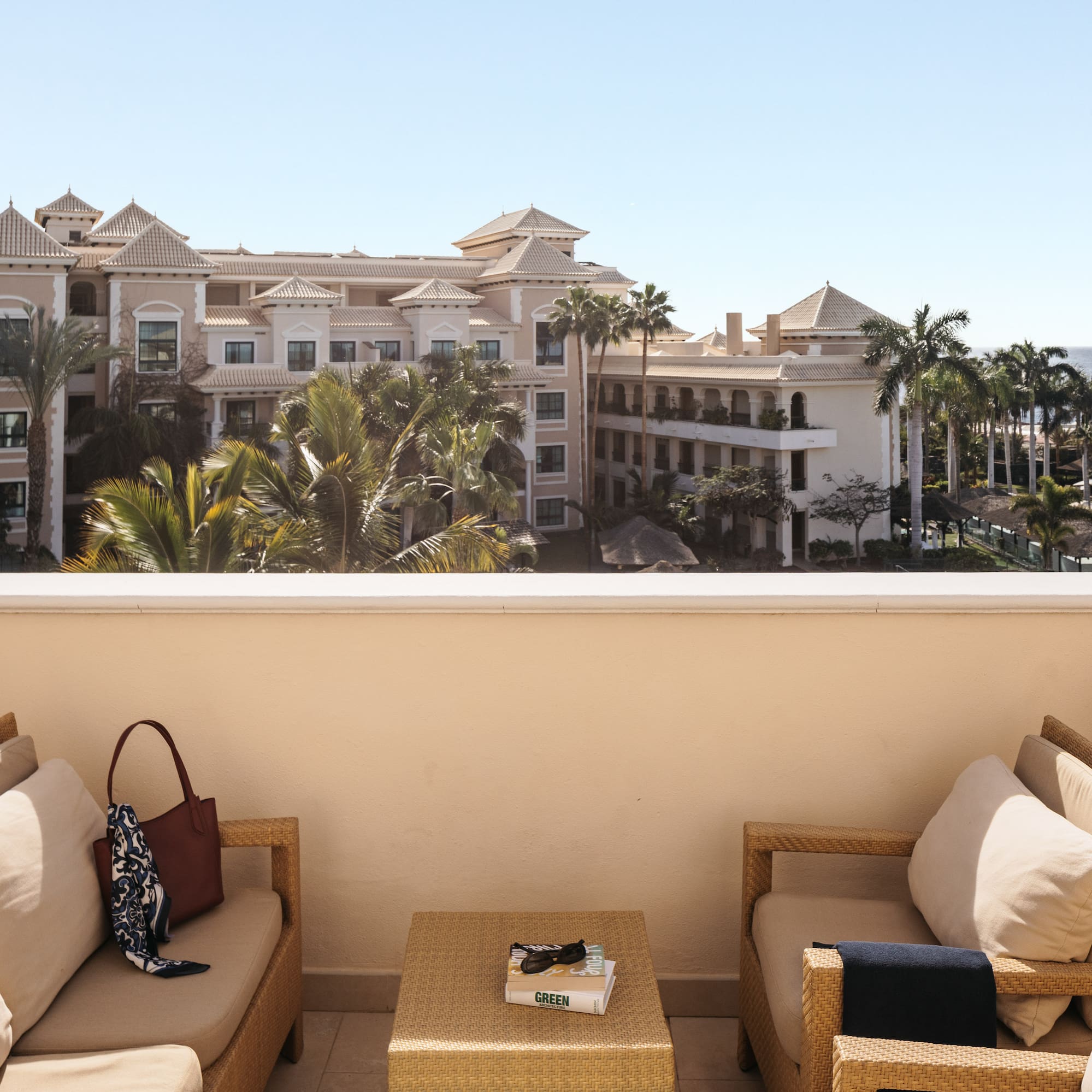 a balcony with a view of a resort and a beach