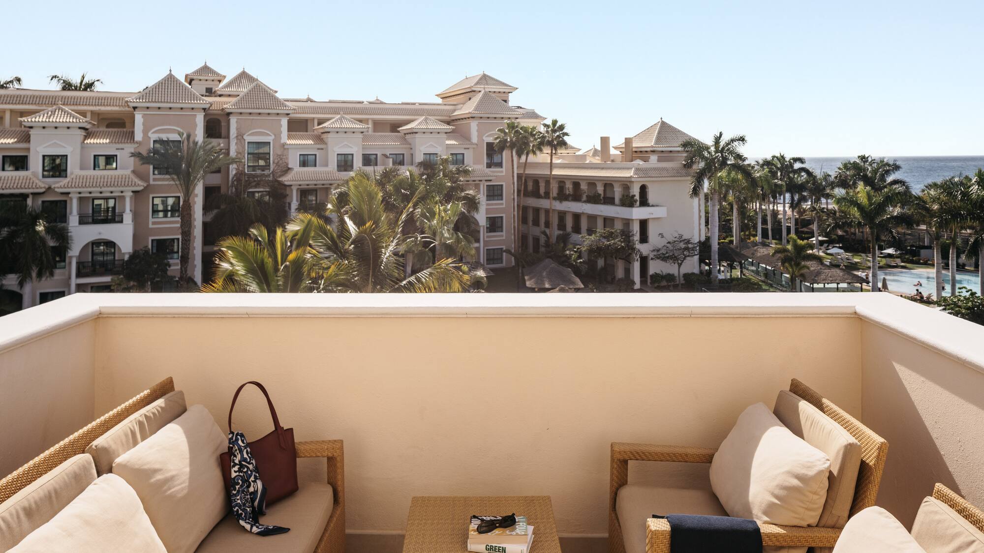 a balcony with a view of a resort and a beach